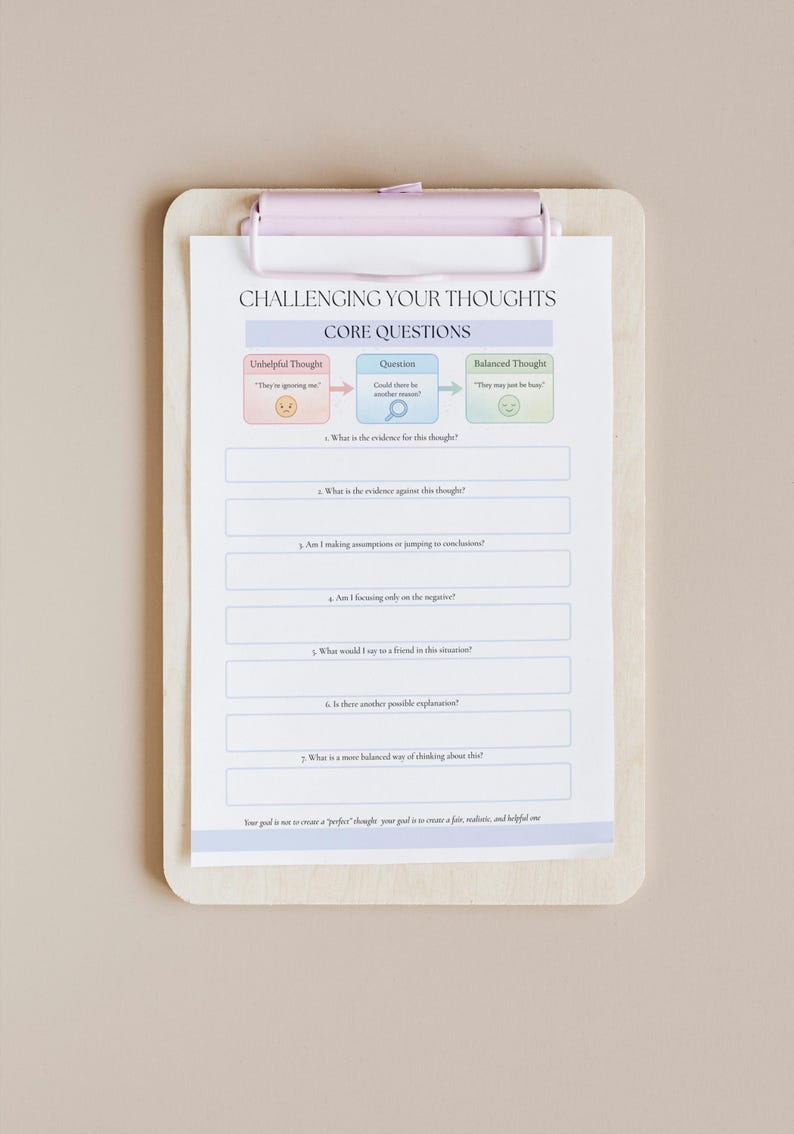 May include: A clipboard with a pink clip holds a worksheet titled "Challenging Your Thoughts." The worksheet has sections for "Unhelpful Thought," "Question," and "Balanced Thought," with prompts to analyze and reframe thinking patterns.