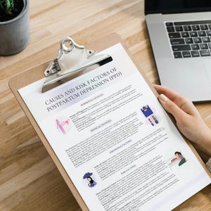 May include: A clipboard with a printed document titled "CAUSES AND RISK FACTORS OF POSTPARTUM DEPRESSION (PPD)". The document includes sections on hormonal, physical, and emotional factors, along with risk factors. A laptop and a potted plant are also visible.