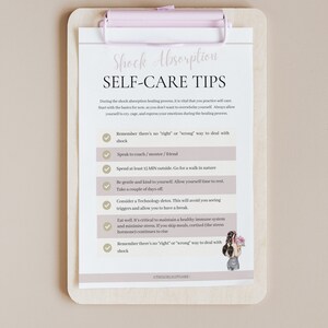 May include: A checklist on a clipboard with a pink clip, titled "Shock Absorption Self-Care Tips". The checklist includes tips for dealing with shock, such as taking a break from technology, spending time in nature, and eating well.