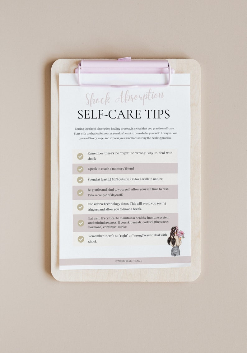 May include: A checklist on a clipboard with a pink clip, titled "Shock Absorption Self-Care Tips". The checklist includes tips for dealing with shock, such as taking a break from technology, spending time in nature, and eating well.