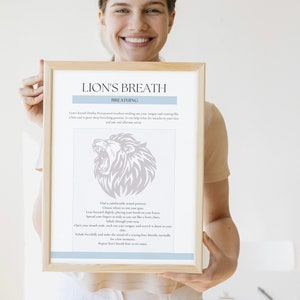 May include: A framed print with the text "LION'S BREATH" and instructions for a breathing exercise. The print features a lion illustration and is held by a person.