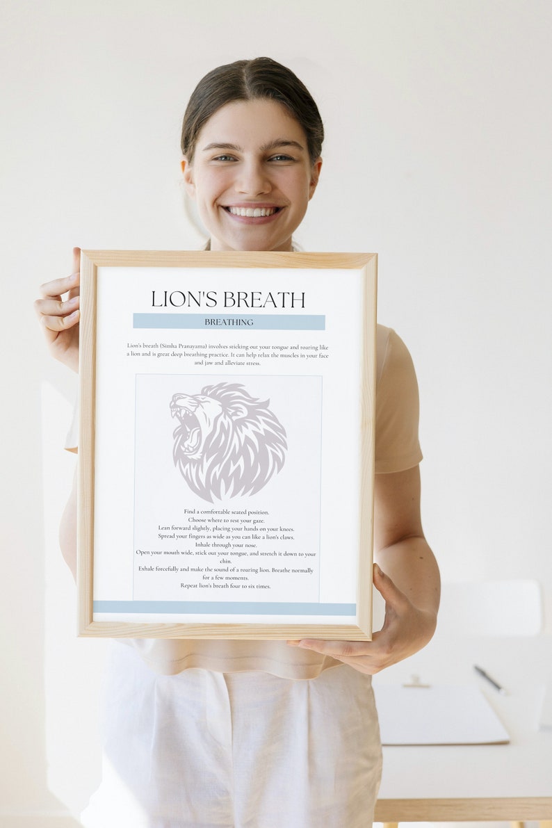 May include: A framed print with the text "LION'S BREATH" and instructions for a breathing exercise. The print features a lion illustration and is held by a person.