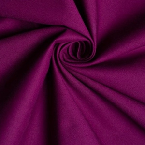 May include: A close-up of a deep purple fabric with a soft, smooth texture. The fabric is folded and draped, showcasing its rich color and luxurious feel.