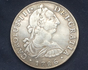 May include: Silver coin with a portrait of King Charles III of Spain, the inscription "CAROLUS III DEI GRATIA" and the date "1786".