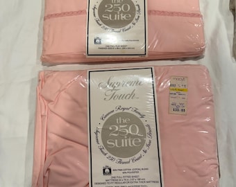 May include: Two packages of light pink Supreme Touch bed sheets by Cannon Royal Family. The top package is a full flat sheet measuring 206 x 243 cm. The bottom package is a full fitted sheet for a 137 x 190 cm mattress. Both have 250 thread count.