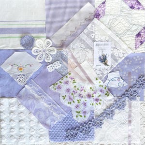 May include: A collage of vintage textiles in shades of white and lavender. Includes lace doilies, handkerchiefs with floral embroidery, and a small card with lavender sprigs. The arrangement evokes a sense of nostalgia and delicate craftsmanship.