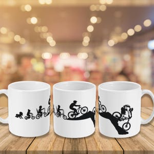 May include: A white ceramic mug with a black handle and the text "But First, Coffee" in a bold, black font. The mug is set against a neutral background, highlighting its simple design.