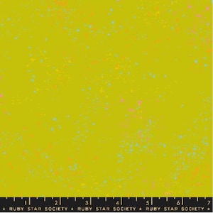 May include: A close-up of a fabric with a chartreuse background and colorful speckles in shades of pink, orange, and blue. The fabric has a ruler at the bottom with the text "RUBY STAR SOCIETY".