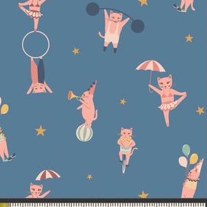 May include: Blue fabric with a repeating pattern of circus cats. The cats are performing various acts, including balancing on balls, lifting weights, and riding bicycles. The cats are pink with white accents, and the background is a dark blue with yellow stars.