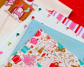 May include: A collection of folded fabric pieces featuring various holiday-themed prints. Patterns include a fireplace scene, red and white stripes, a light blue speckled design, and a cream fabric with colorful illustrations of snowmen, gifts, and ornaments.