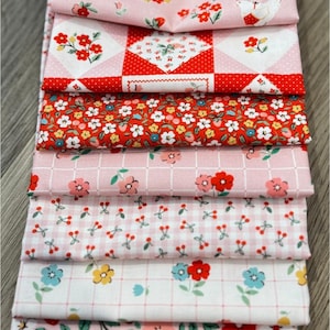 Puede incluir: Una pila de tela floral rosa y roja. Las telas presentan varios patrones, incluyendo flores, gallinas y cuadros vichy. Los colores son predominantemente rosa, rojo, blanco y amarillo, creando una estética alegre y vintage.