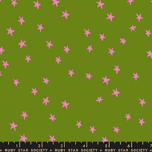 May include: Green fabric with a pattern of pink stars. The stars are scattered across the fabric. The fabric is from Ruby Star Society.