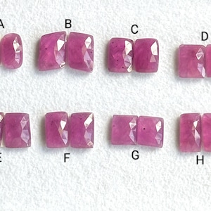 Puede incluir: Ocho pares de piedras preciosas de rubí rosa, etiquetados de la A a la H. Cada par está dispuesto uno al lado del otro.