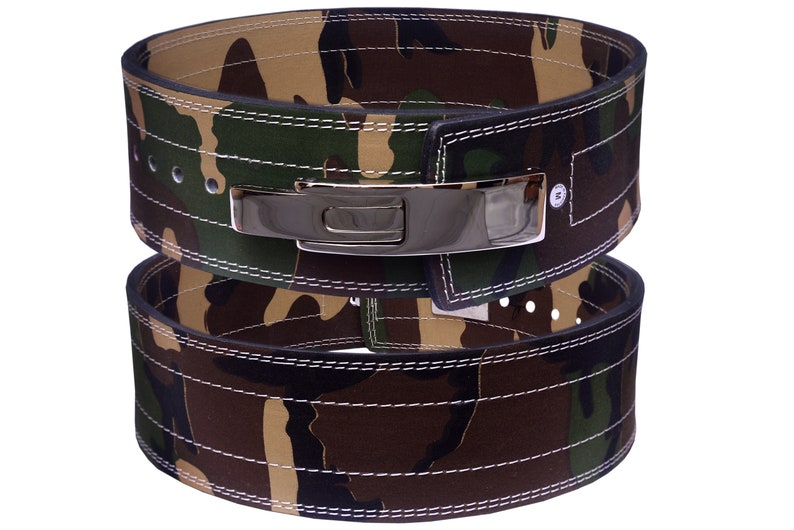 May include: A camouflage weightlifting belt with a silver buckle. The belt is made of leather and has a double-stitched design.