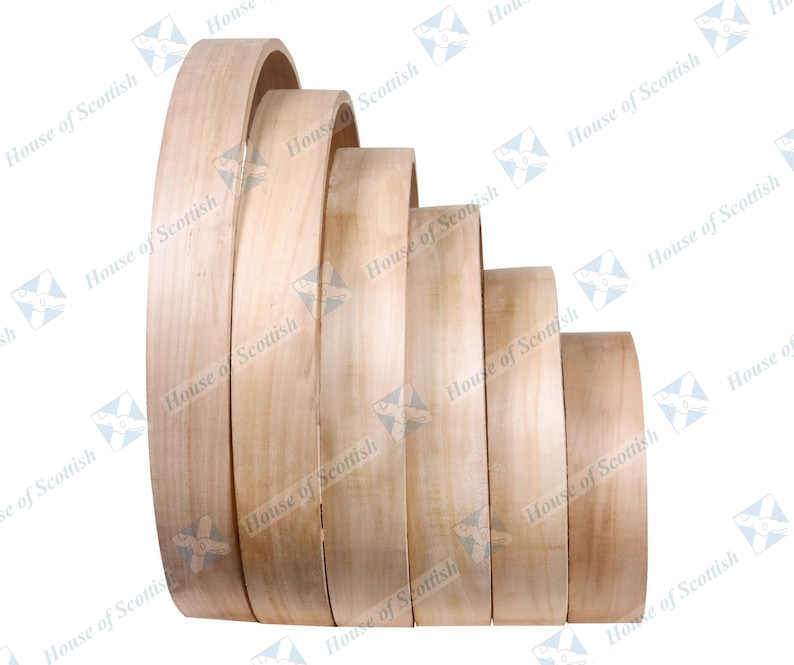 May include: A set of six wooden hoops of varying sizes, stacked in a graduated pattern. The hoops are made of light-colored wood and have a smooth, polished finish.