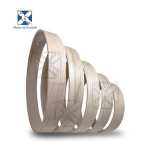 Op de afbeelding: Een set van vijf trapsgewijze ronde houten hoepels, gerangschikt in een geneste, overlappende formatie. De hoepels zijn gemaakt van lichtgekleurd, onafgewerkt hout met een zichtbare nerf, met een glad, gebogen oppervlak en een natuurlijke textuur.
