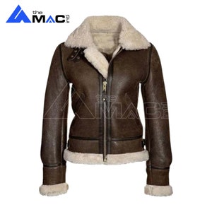 May include: A brown leather jacket with a shearling collar and lining. The jacket has a zipper closure and two pockets.