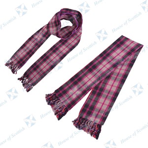 May include: Two tartan scarves with fringed edges. The scarves display a pattern of black, grey, and pink squares. The text "House of Scottish" is visible in the background.