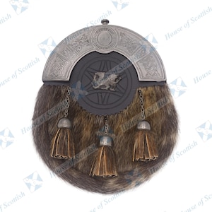 May include: A brown and black fur sporran with a silver metal embellishment featuring a Celtic knot design and a small dragon. The sporran has three brown tassels.