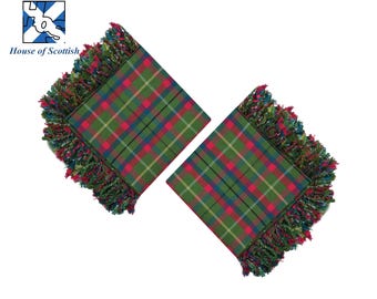 May include: Two green, red, and blue plaid fabric squares with fringed edges. The fabric has a tartan pattern.