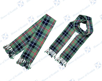 May include: Two green, red, and blue plaid scarves with fringed edges. One scarf is tied in a loop, and the other is laid out flat.