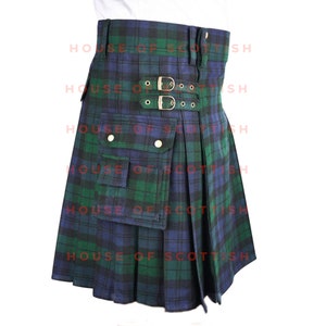 May include: A green and blue tartan kilt with a large cargo pocket and two buckles on the front. The kilt is pleated and has a traditional design.