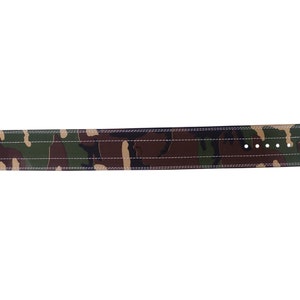 May include: A camouflage weightlifting belt with a metal buckle. The belt is made of leather and has a stitched design.