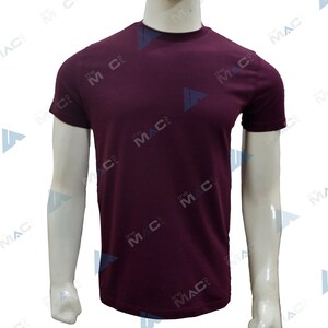 May include: A plain burgundy crew neck t-shirt on a mannequin. The short-sleeved top has a simple design and is made of a smooth fabric. The mannequin's arms are visible.