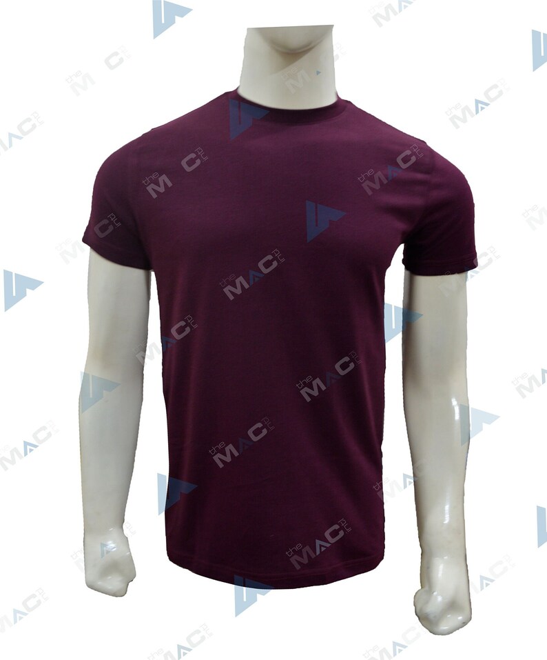 May include: A plain burgundy crew neck t-shirt on a mannequin. The short-sleeved top has a simple design and is made of a smooth fabric. The mannequin's arms are visible.