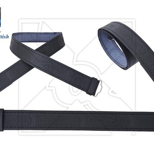 May include: Black leather belt with a Celtic knot design. The belt is shown in three different positions.