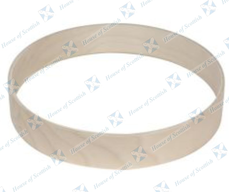 May include: A plain, light brown wooden ring, possibly for a drum or other musical instrument.
