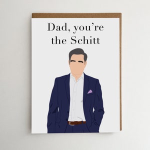 May include: Greeting card with the text "Dad, you're the Schitt" above an illustration of a man in a navy blue suit, white shirt, and purple pocket square. The card has a brown border.