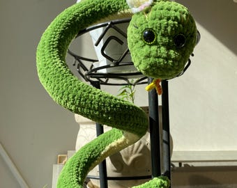 A crocheted plush snake. A gift for reptile lovers. A handmade decorative toy and home accessory