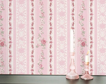 May include: Pink and white striped wallpaper with a floral pattern. The wallpaper features vertical stripes with alternating designs of roses and decorative elements. A black shelf holds a pink box, a decorative box, a bird statue, and two pink candle holders.