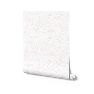 May include: A roll of white wallpaper with a subtle pattern of gray branches and leaves.