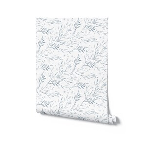 May include: A roll of blue and white floral wallpaper with a delicate pattern of leaves and flowers.