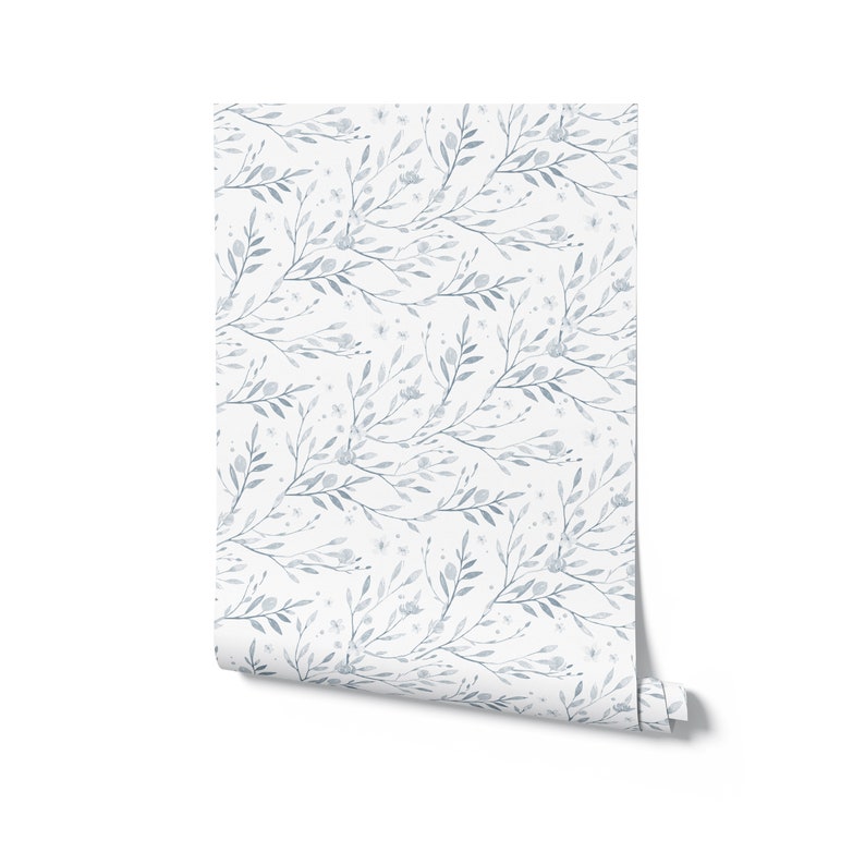 May include: A roll of blue and white floral wallpaper with a delicate pattern of leaves and flowers.