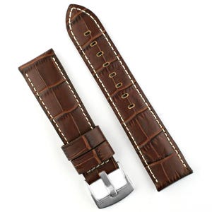 May include: Two-piece brown leather watch strap with a crocodile pattern. The strap features white stitching and a silver-colored buckle. The watch band is designed to be attached to a watch face.