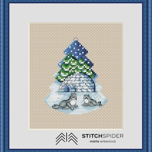 Op de afbeelding: Borduurpatroon met een blauwe en groene kerstboom met een witte iglo en twee zeehonden eronder. Het patroon is getiteld "StitchSpider" met de naam "mária erbenová" eronder.