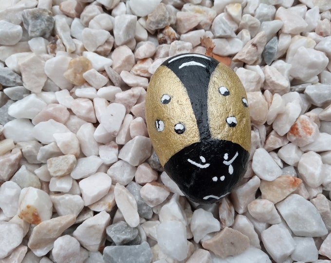 Painted pebble ladybug gold and black