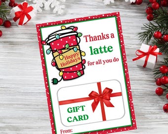 May include: A red and white gift card with a red bow and the text "Thanks a latte for all you do" and "Gift Card". The card has a cartoon image of a red coffee cup with lights wrapped around it and the text "Happy Holidays".