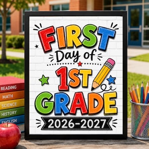 May include: A framed sign with a white brick background featuring the colorful text First Day of 1st Grade 2026-2027. The design includes a yellow pencil illustration, red, green, and blue stars, and decorative black lines on a white rectangular board.