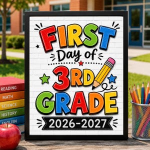May include: A framed sign with a white brick background featuring the colorful text FIRST DAY OF 3RD GRADE 2026-2027. The design includes a yellow pencil graphic, small stars, and decorative lines, presented in a black frame on a wooden surface.