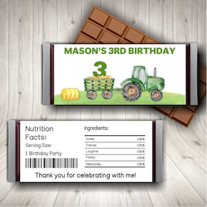 May include: Chocolate bar with a custom label for a 3rd birthday. The label features a green tractor pulling a wagon filled with hay, and the text "MASON'S 3RD BIRTHDAY". The back of the bar has a nutrition facts label.