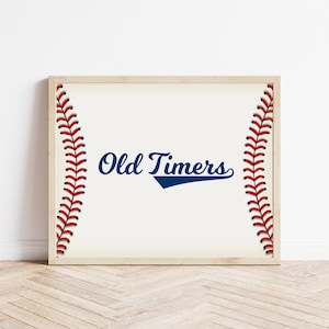 May include: A framed print featuring a baseball stitch design and the text "Old Timers" in blue cursive lettering.