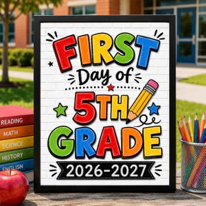 May include: A framed sign with a white brick background featuring the colorful text FIRST DAY OF 5TH GRADE 2026-2027. The design includes a yellow pencil illustration, small stars, and decorative lines, presented in a black frame.