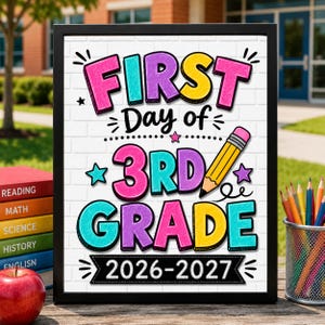May include: A framed sign with a white brick background featuring the colorful text FIRST DAY OF 3RD GRADE 2026-2027. The design includes a yellow pencil graphic, small stars, and decorative flourishes in pink, purple, yellow, and teal.