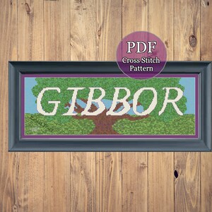 May include: Cross stitch pattern PDF for a design featuring a tree with the word "GIBBOR" written on it. The tree is green and brown with a blue sky and white clouds in the background. The words "Rabbit Tears" are visible at the bottom left of the design.
