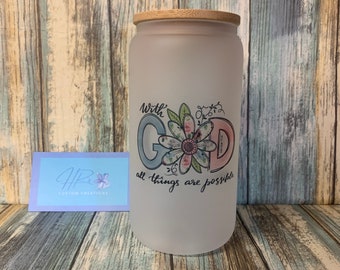 May include: A frosted glass jar with a bamboo lid. The jar has a floral design with the words "with God all things are possible".