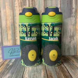 May include: Two green and black water bottles with a tractor pattern and the names Kayson and Jacob on them.